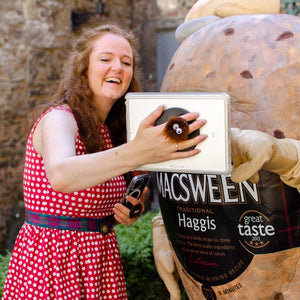 Alison Grieve and Hamish the Haggis watching iPad and holding iPad with Haggis tablet holder